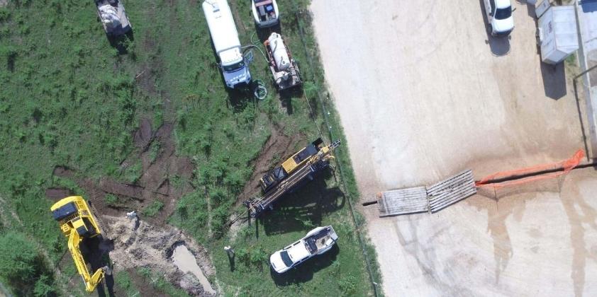 Aerial view of pipeline installation site with heavy machinery.